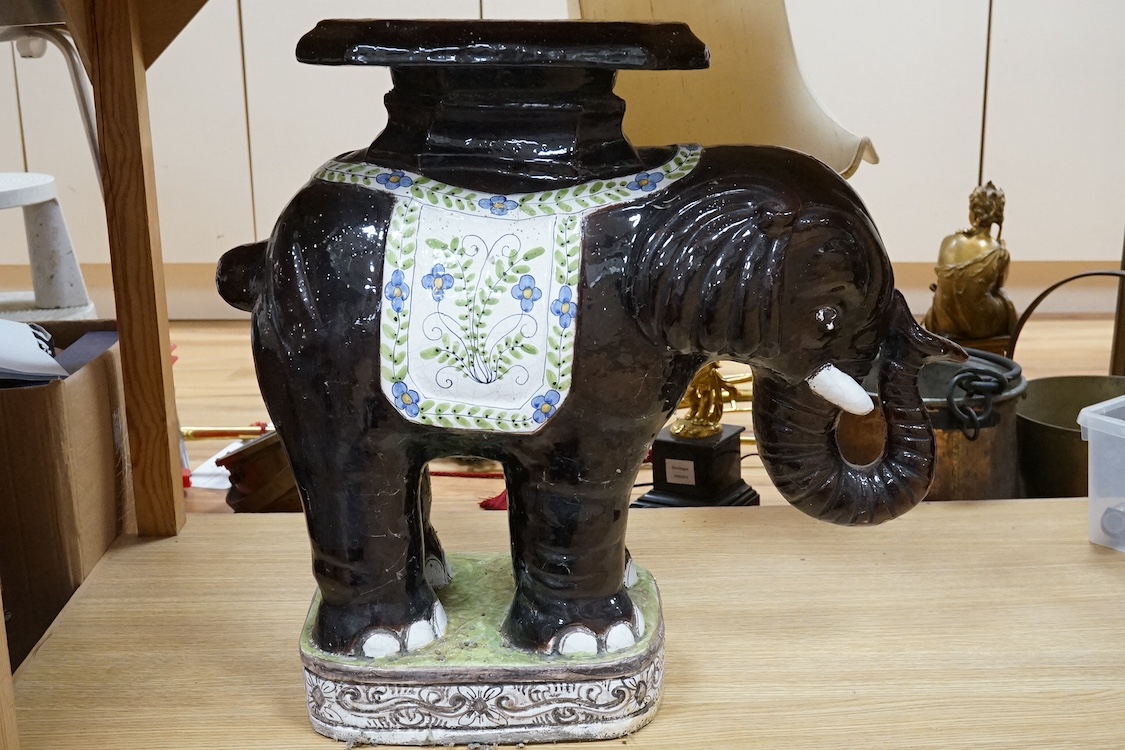 A modern Chinese style pottery conservatory seat in the form of an elephant, 64cm wide. Condition - fair